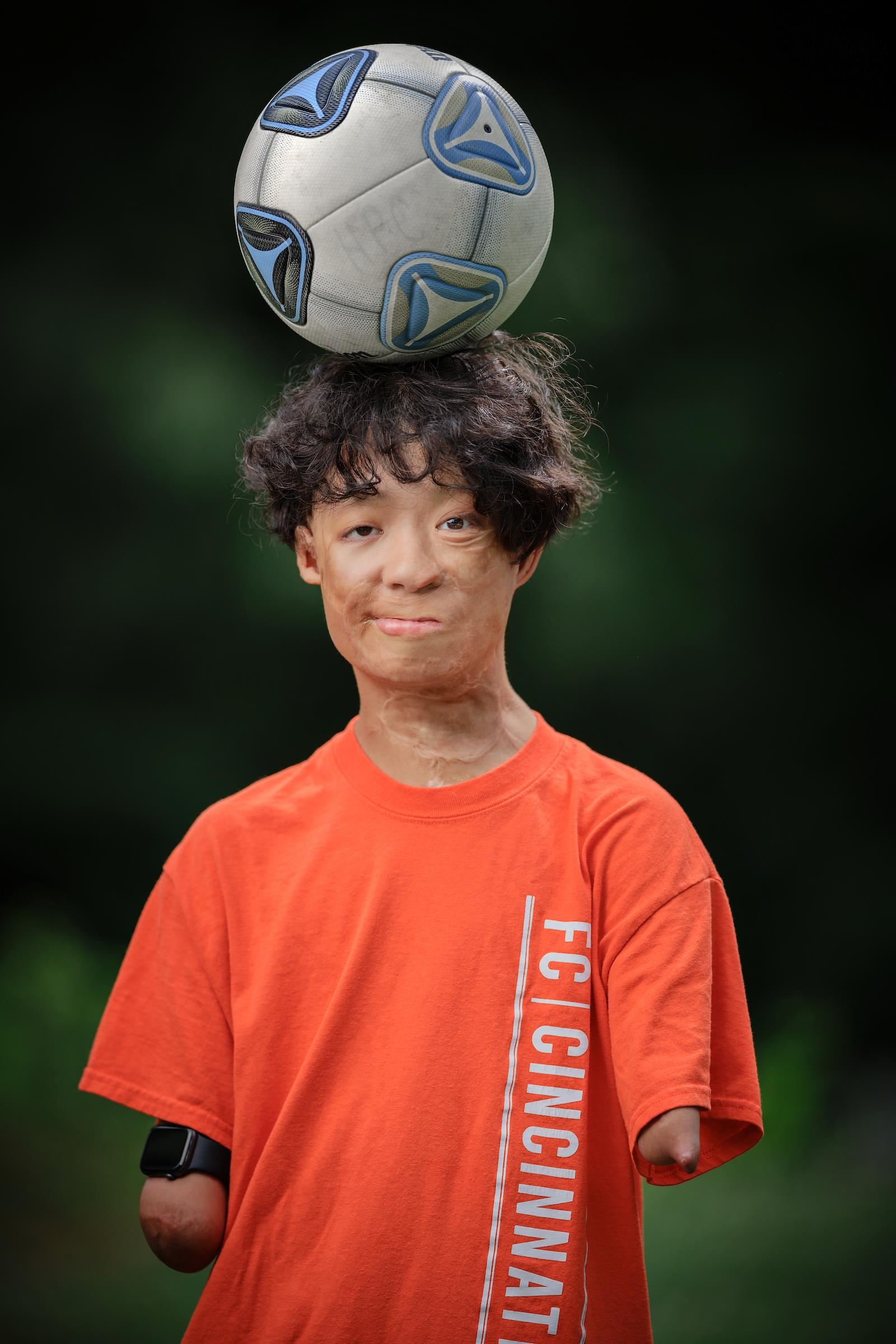 person with soccer ball on their head